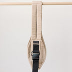 Side view of the Sand Beige Rouu Baby II hip carrier on the hip