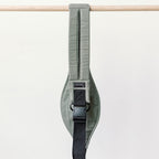 Baby seated in the Olive Rouu Baby II ergonomic hip carrier